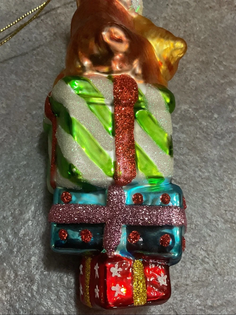 Glass Dog Ornament Sitting on Stacked Presents - Brown, Gold, Green